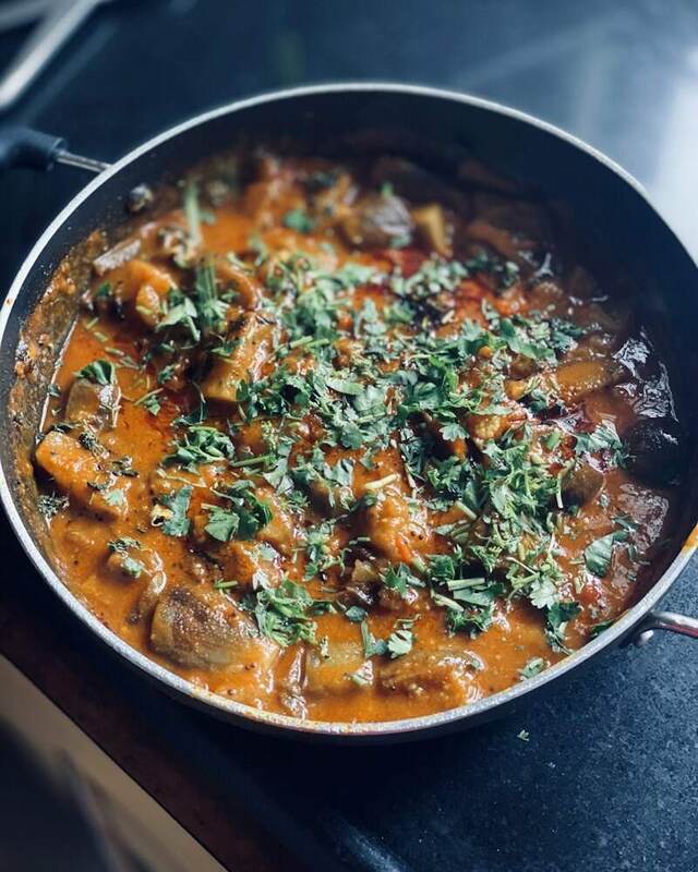A pan of home-style South Indian curry topped with fresh coriander